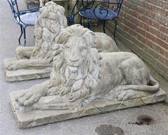 A pair of reconstituted stone garden statues modelled as seated lions, 4ft